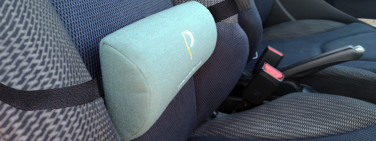 Lifestyle shot showing a lumbar roll being used in the car
