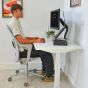 JOSHO Homeworker Electric Sit-Stand Desk - lifestyle shot - white desk and frame, side angle view, showing seated position