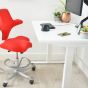 JOSHO Homeworker Electric Sit-Stand Desk - lifestyle shot - white desk and frame, side angle view, showing seated position