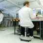 Bimos Labster Stool - lifestyle shot showing technician sitting on the white version