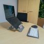 Lifestyle shot of the Vision Laptop Stand, along with a standalone keyboard and mouse, in an office environment