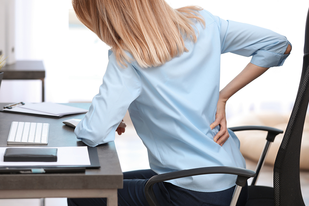 Woman at work suffering bad back