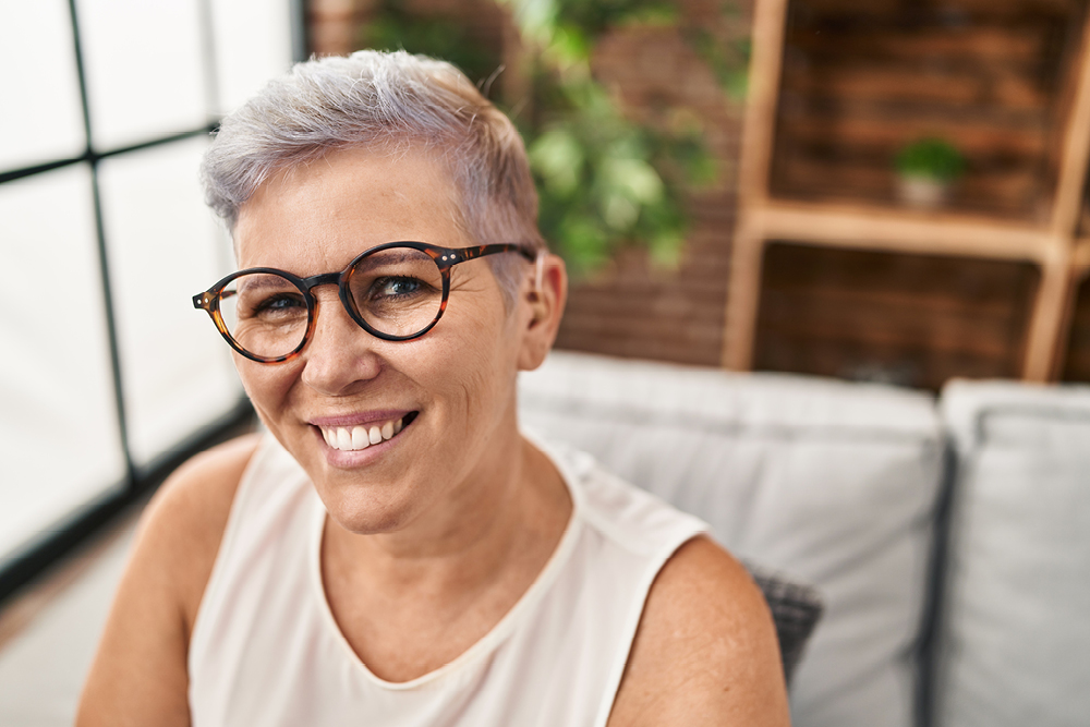 Smiling woman wearing a hearing aid