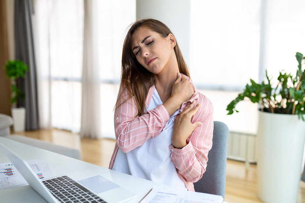 Woman with shoulder pain from working from home