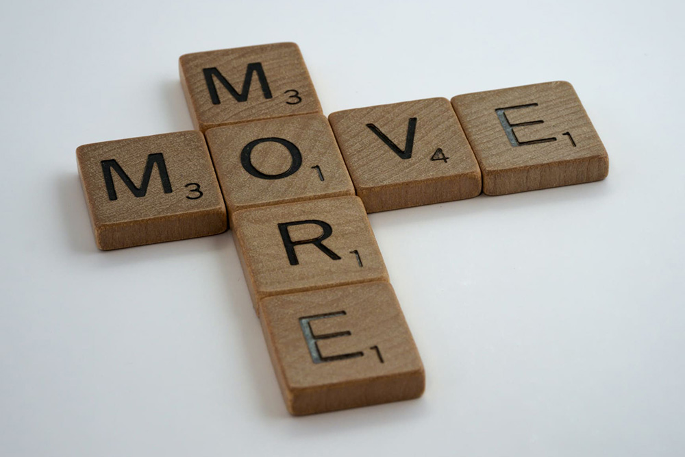 Scrabble pieces, spelling out 'Move More'
