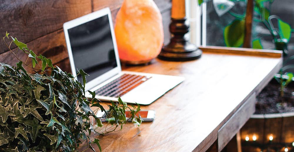 Wooden desk with warm lighting for a homely work environment