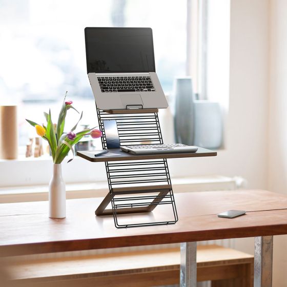 Standfriend Sit-Stand Platform (Black Frame) - front angle view lifestyle shot, showing 'in use' with a laptop and keyboard