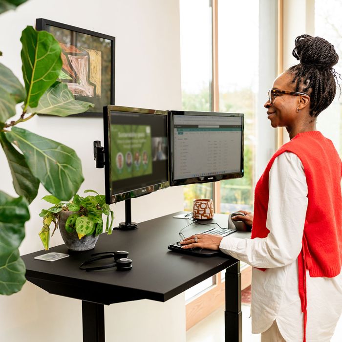 JOSHO Homeworker Electric Sit-Stand Desk - lifestyle shot - black desk and frame, front angle view, showing standing position