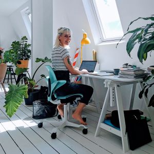 HÅG Capisco Puls 8020 Sea Green Office Chair - lifestyle shot, shown in an office environment