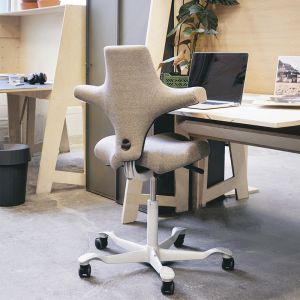 HÅG Capisco 8106 Straw Office Chair - lifestyle shot, shown in an office environment