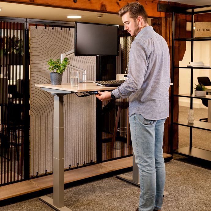 JOSHO Homeworker Beech Electric Sit-Stand Desk - lifestyle shot, shown raised in the standing position
