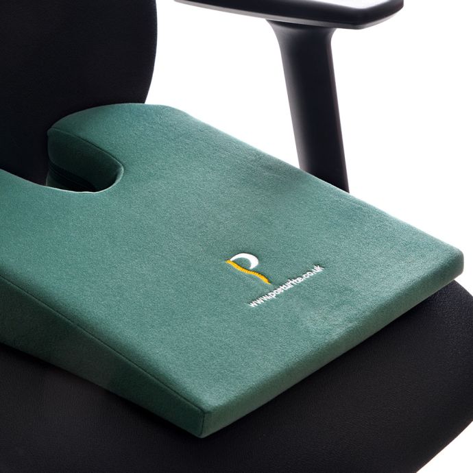 Posturite Coccyx Cut-out Wedge - close up, shown on an ergonomic chair