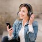 Tilde® Pro C+ Noise-Cancelling Bluetooth Dongle Headphones - lifestyle shot, showing a woman using the headphones during a phone call