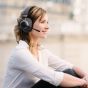 Tilde® Pro C+ Noise-Cancelling Bluetooth Dongle Headphones - lifestyle shot, showing a woman using the headphones