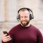 Tilde® Pro C+ Noise-Cancelling Bluetooth Dongle Headphones - lifestyle shot, showing a man using the headphones during a phone call