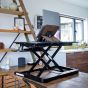 Lifestyle shot showing the Deskrite 100E Sit-Stand Platform in the open/standing position