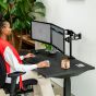 JOSHO Homeworker Electric Sit-Stand Desk - lifestyle shot - black desk and frame, front angle view, showing seated position