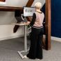 KOJI Italian Oak Electric Sit-Stand Desk - lifestyle shot, shown raised in the standing position