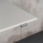 KOJI White Electric Sit-Stand Desk - close up of desktop and switch