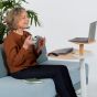 Otto Laptop Table (Oak Top, Grey Base) - lifestyle shot showing the table in use during a video call, providing good ergonomic posture