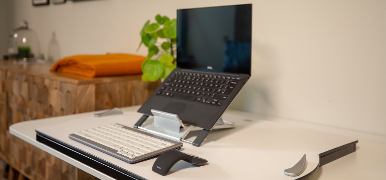 Good ergonomic homeworking setup, featuring the Opløft Sit-Stand Platform, along with a laptop stand, separate keyboard and mouse