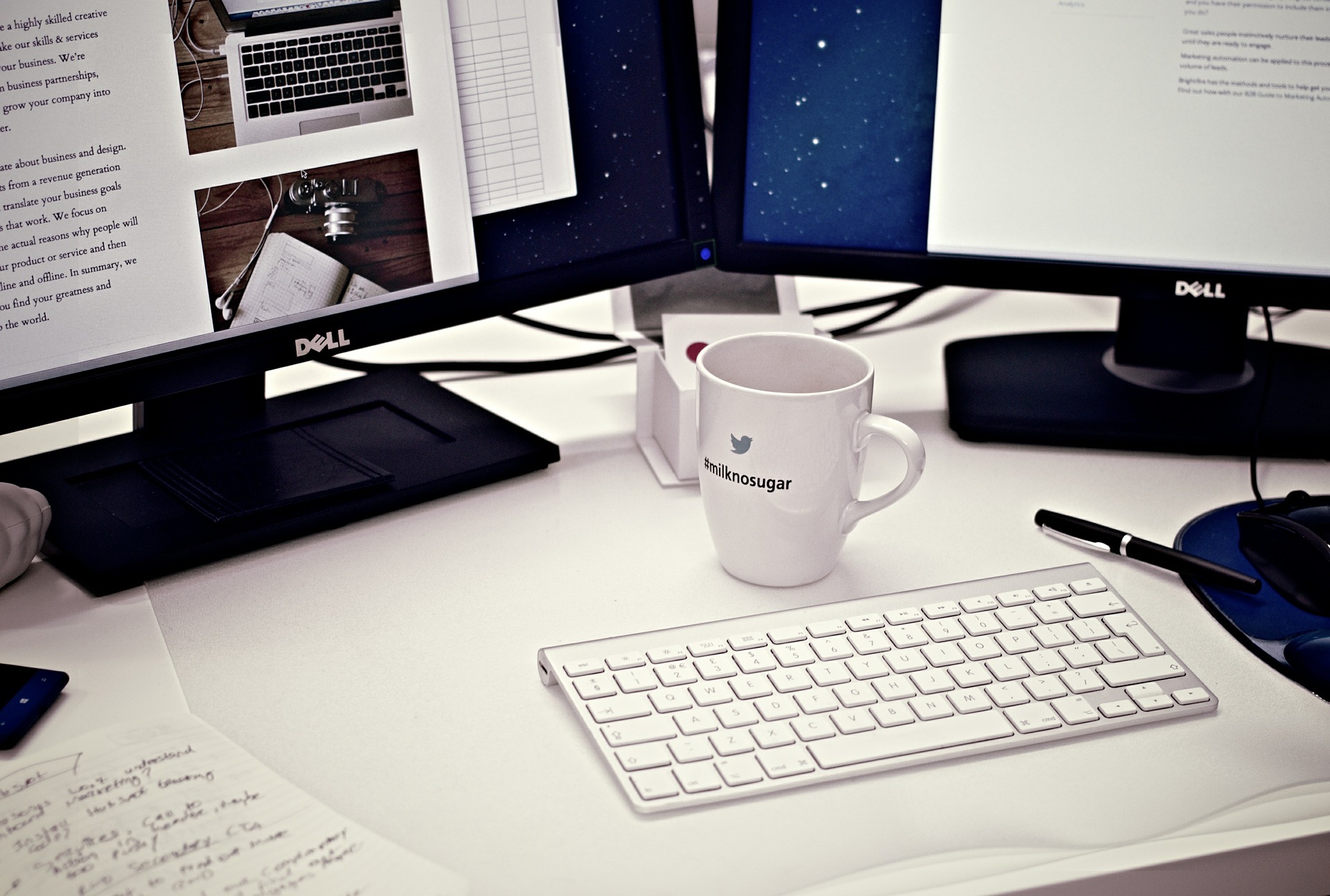 Typical office desk set-up, showing monitors, keyboard and mouse