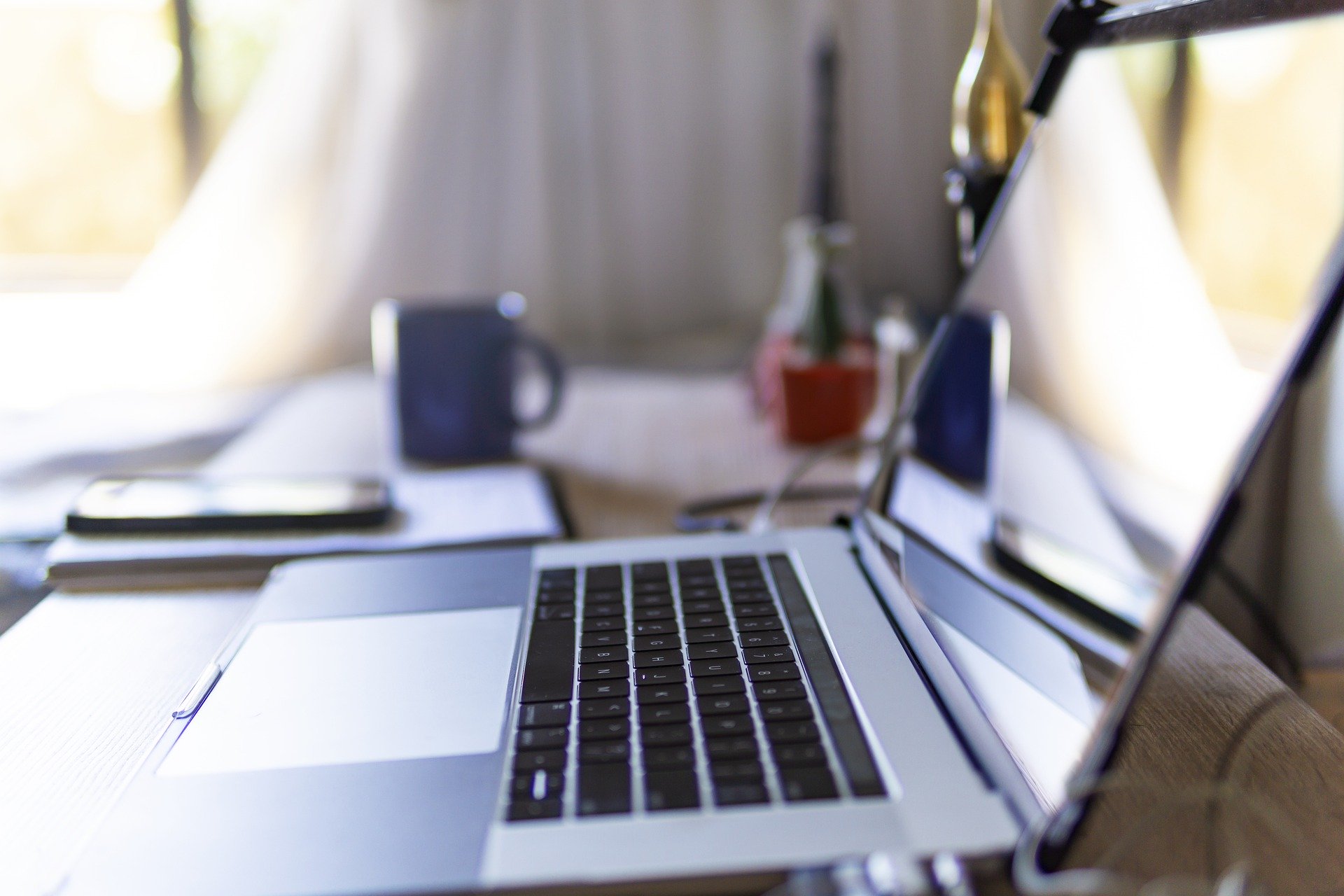 Lifestyle image showing a close up of an open laptop on a home office desk