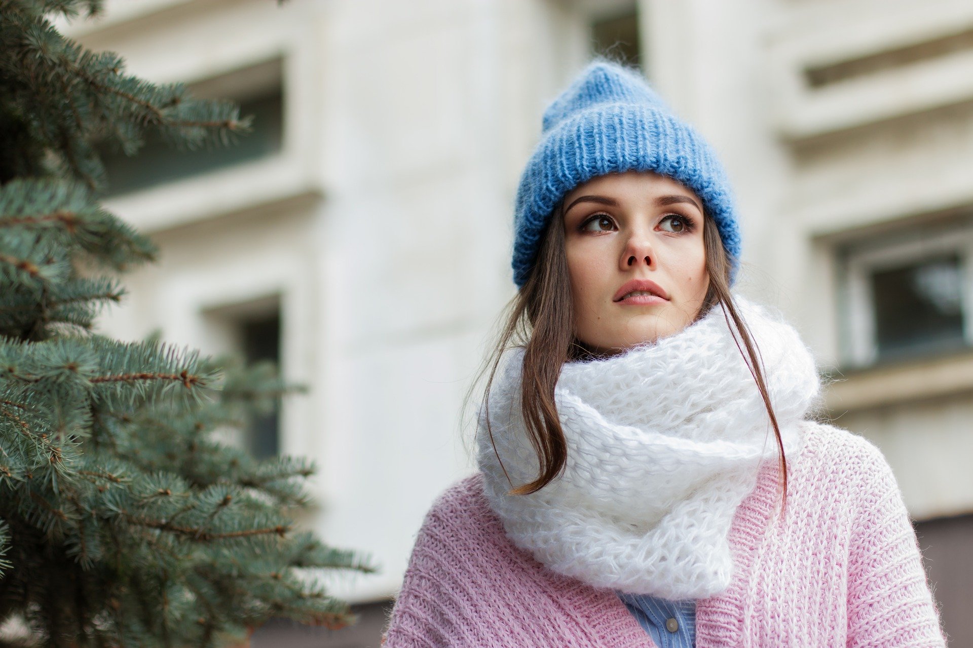 Woman wrapped up warmly while walking outside