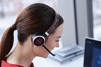 Image of woman in the office using her Jabra Evolve 65 headset