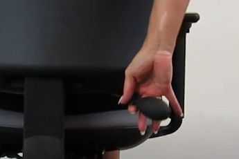 Back view of the Homeworker Plus Ergonomic Chair, showing a woman holding onto the lumbar pump