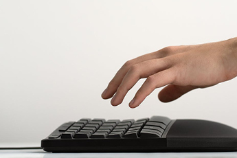 Side view of someone using the Microsoft Ergonomic Keyboard