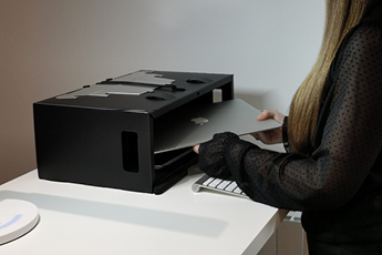 Image of woman using Box Office Pro as a storage box placing her office equipment in it