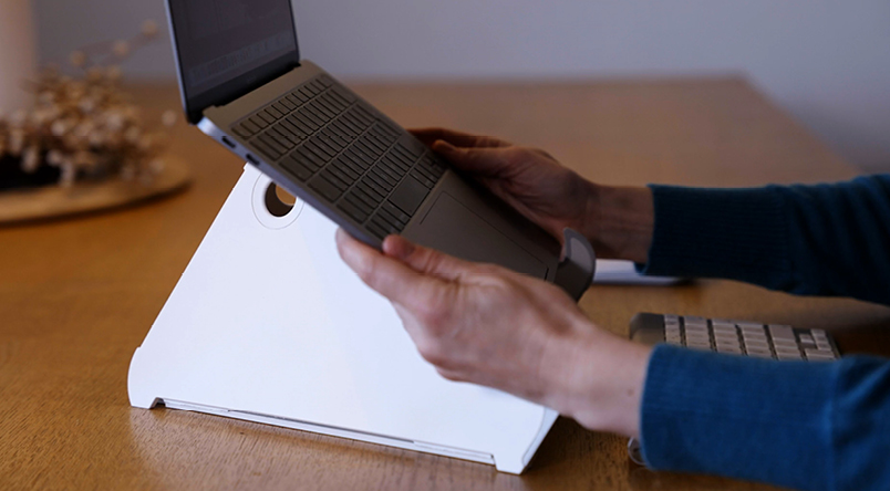Image of person placing laptop on the Oripura Laptop Stand