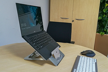 Image of Vision Laptop Stand being used in an office with Laptop placed on stand 
