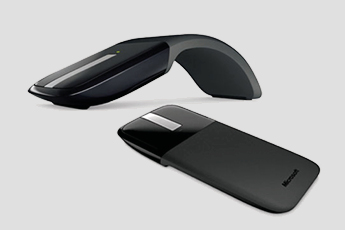 Image of Microsoft Arc Touch Mouse - one with curve and also showing it laid flat