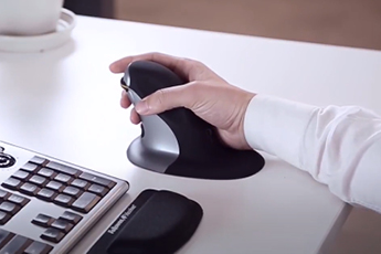 Image of person gripping and using the Penguin Mouse