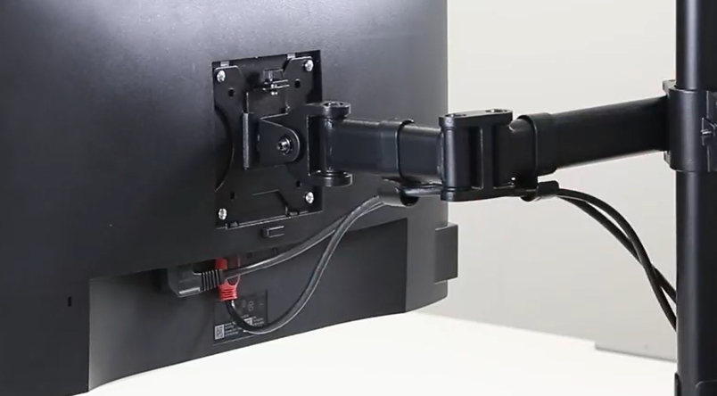 Close up image of the back of the monitor with the Reflex Monitor Arm connected showcasing the cable management the monitor arm has to keep cables tidy and safe