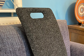 Close up lifestyle image of the anthracite MEDesign Backfriend, shown on an armchair