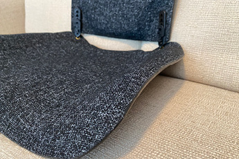 Close up lifestyle image of the anthracite MEDesign Backfriend, shown on a sofa