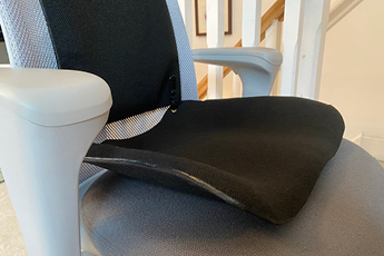 Lifestyle image of the black MEDesign Backfriend, shown on an office chair