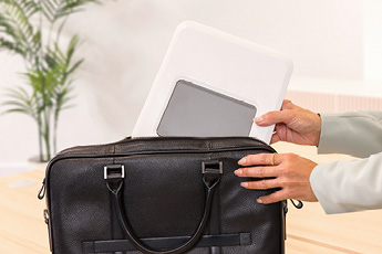 Lifestyle image of the Breyta™ Laptop Stand, showing how it can be easily folded down for 'on-the-go' working