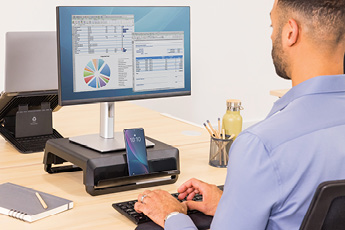 Lifestyle image of the Breyta™ Monitor Riser, shown in use with a monitor and home office setup