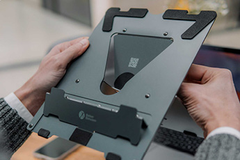 Image of the Ergo-Q 160 Laptop Stand, showing someone unfolding it, ready to mount a laptop on