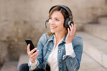 Woman using the Tilde® Pro C+ Noise-Cancelling Bluetooth Headphones during a call