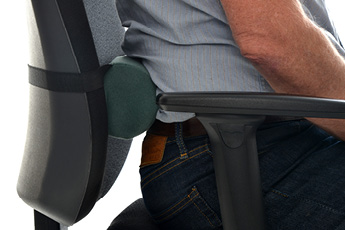 Side image of a lumbar roll strapped to an ergonomic chair