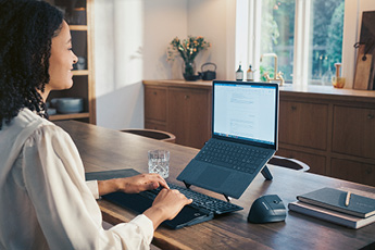 Lifestyle image of the Contour RollerMouse Pro, shown in use with a separate keyboard and laptop stand