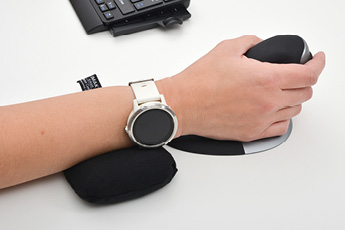 Lifestyle image of the ErgoBeads Mouse Wrist Rest, shown in use with a Penguin Vertical Mouse