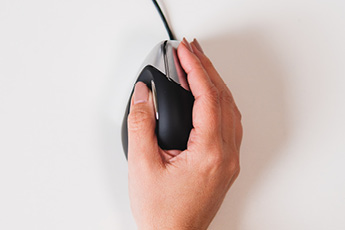 Lifestyle birdseye view of the Evoluent VerticalMouse 3 Right, showing correct grip positioning