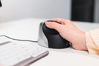 Lifestyle side view of the Evoluent VerticalMouse 3 Right, showing hand positioning