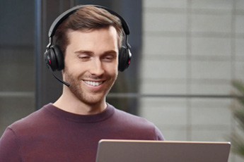 Lifestyle image of the Jabra Evolve2 65 Bluetooth MS Stereo Headset (USB-A), shown in use during a call